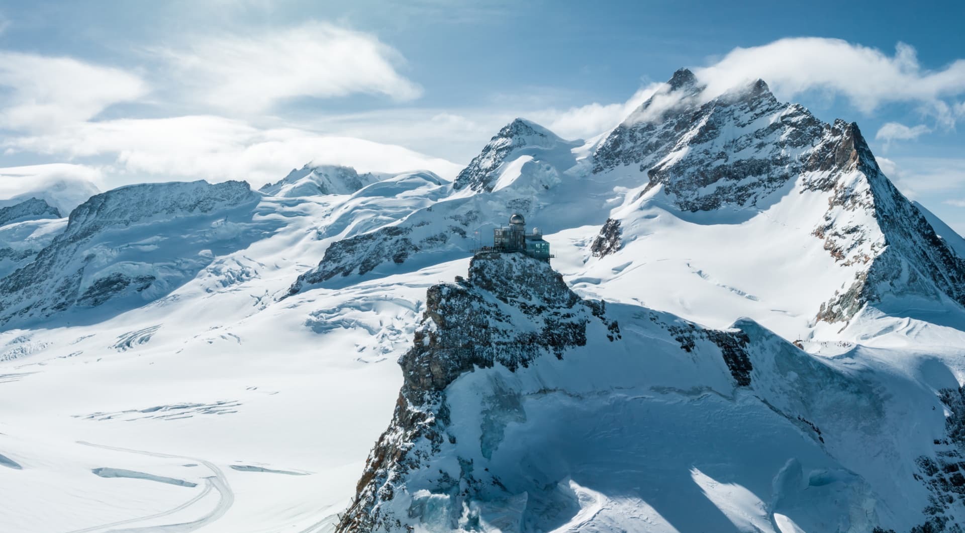 Snow-covered Swiss Alps beneath a clear sky